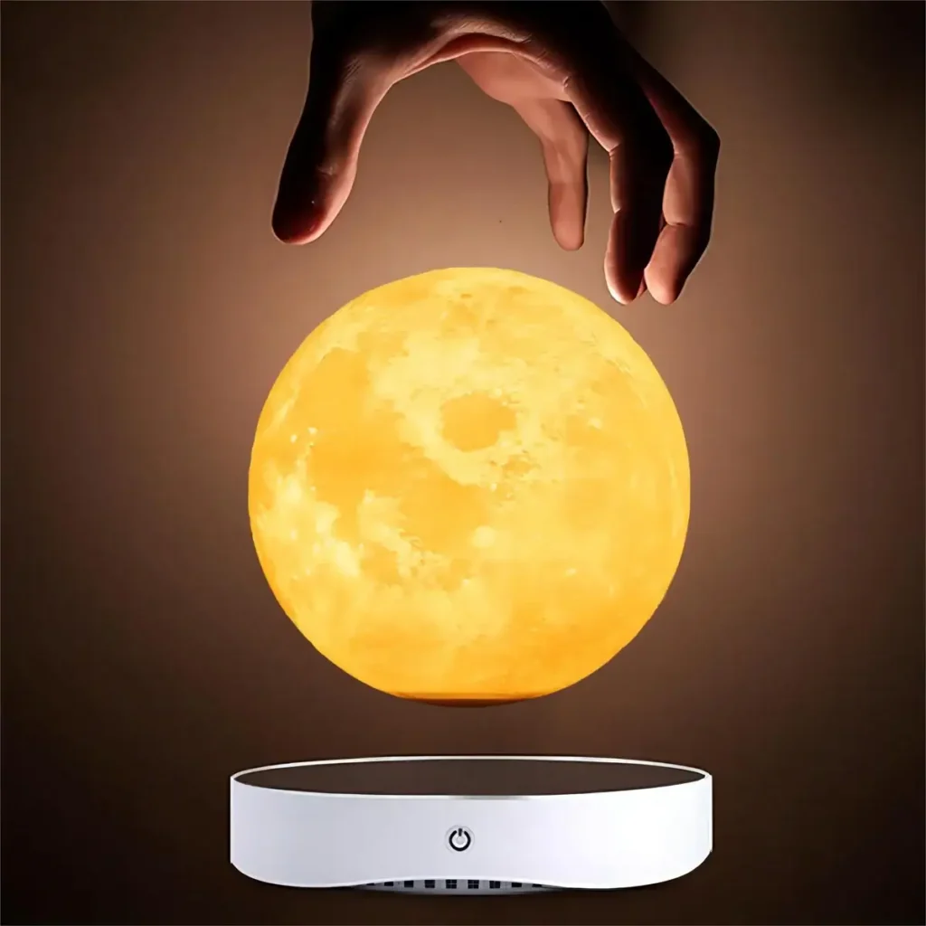 Hand hovering above a glowing moon lamp, showcasing a science-inspired decor piece and educational toy for astronomy enthusiasts and science lovers.