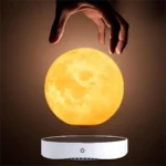 Hand hovering above a glowing moon lamp, showcasing a science-inspired decor piece and educational toy for astronomy enthusiasts and science lovers.