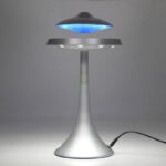 Modern UFO-shaped LED desk lamp emitting blue light, ideal for science decor and educational spaces.