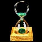 Elegant hourglass with green sand and moss, showcasing a unique science-inspired design.