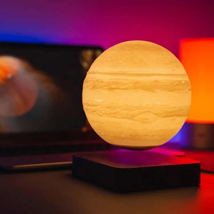 Starry Sky Moon Lamp with Color Changing Light A spherical moon lamp emitting warm light, placed on a black stand with colorful ambient lighting in the background, creating a cozy and modern decor setting.