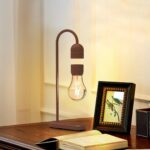 A decorative desk lamp featuring a wooden stand and exposed filament bulb, perfect for adding a warm, nostalgic glow to your space.