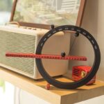 Innovative science gadget with a circular calendar and a red ruler for educational and decorative purposes.