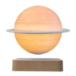 Sun planet lamp with a ring, glowing softly, on wooden base.