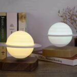 LED lamps resembling Saturn and Earth planets with illuminated globes on wooden bases.