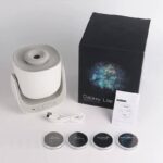 Compact galaxy star projector with adjustable settings, included USB power cable, and four themed discs for creating immersive space and starry sky displays.