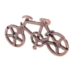 Copper-colored bike gear puzzle model, a mechanical educational toy demonstrating gear mechanisms and bicycle parts.
