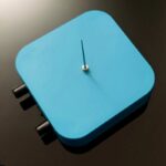 Blue square timer with a minimalist design, featuring a single hand indicator and three control knobs on the side. Perfect for science experiments, educational demonstrations, or decorative science-th.