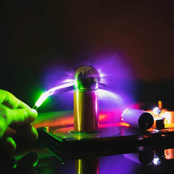 A person touching a plasma globe with colorful electric discharges emanating from the sphere, showcasing a captivating science demonstration.