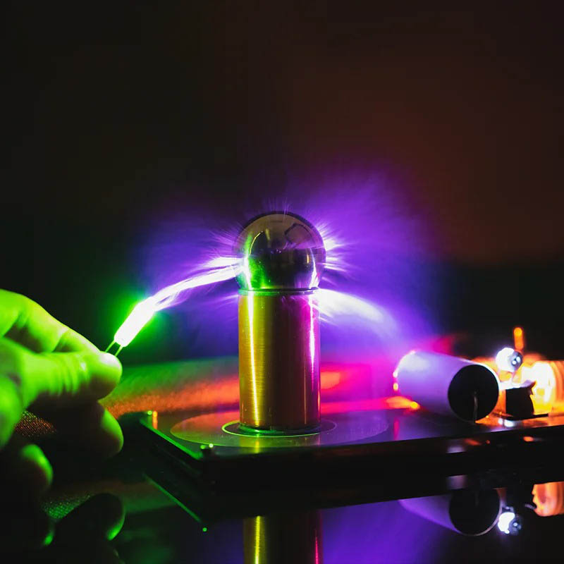 Lightning Ball Plasma Globe - Science Gadgets A person touching a plasma globe with colorful electric discharges emanating from the sphere, showcasing a captivating science demonstration.