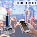 Portable Bluetooth plasma generator creating colorful plasma arcs, with a person holding a smartphone to control it, in a lively crowd setting.