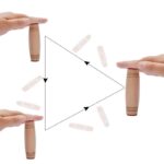 Optical illusion with wooden and plastic objects demonstrating perspective and visual perception.
