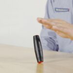 A magnetic levitation device demonstrating magnetic repulsion, with a person controlling the floating object.