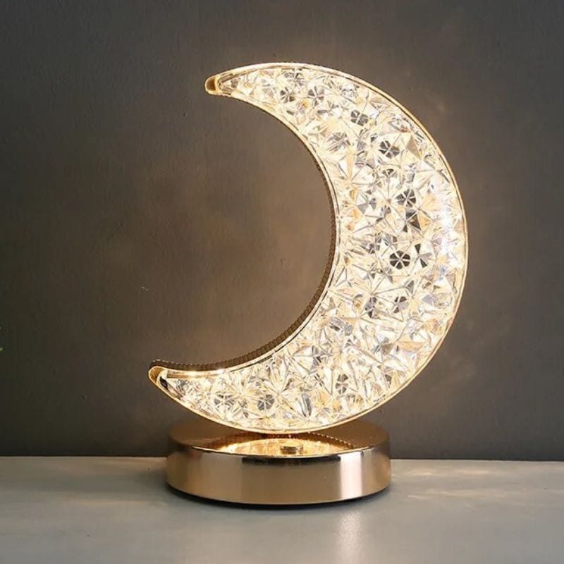 Decorative crystal moon night light with gold base, perfect for adding a magical touch to bedrooms or living spaces. Crafted with sparkling crystals and a sleek gold stand, it creates a calming glow.