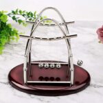 Elegant miniature Newton's Cradle for desk decoration and educational display.