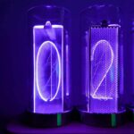 Neon-lit digital number clocks displaying "0" and "2" in a dark setting, showcasing modern LED technology and vibrant illumination.