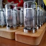 High-quality science demonstration tubes with perforated metal covers displayed on wooden bases, ideal for science experiments and educational decor.
