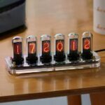 Nixie tube clock showing the time 17:20:12 with vintage-style glowing digits.
