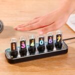 Vaporized numbers display with colorful flames under glass domes, used for educational science demonstrations.