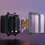 Close-up of a microfluidic device showing transparent chamber, electronic circuitry, and fluid channels, used for scientific experiments and educational demonstrations.
