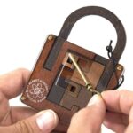 Interactive wooden lock puzzle with a brass key for educational and decorative purposes.