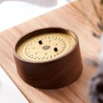 Wooden clock puzzle game with movable black balls and numbered dial, ideal for teaching children time-telling skills in a fun and interactive way.