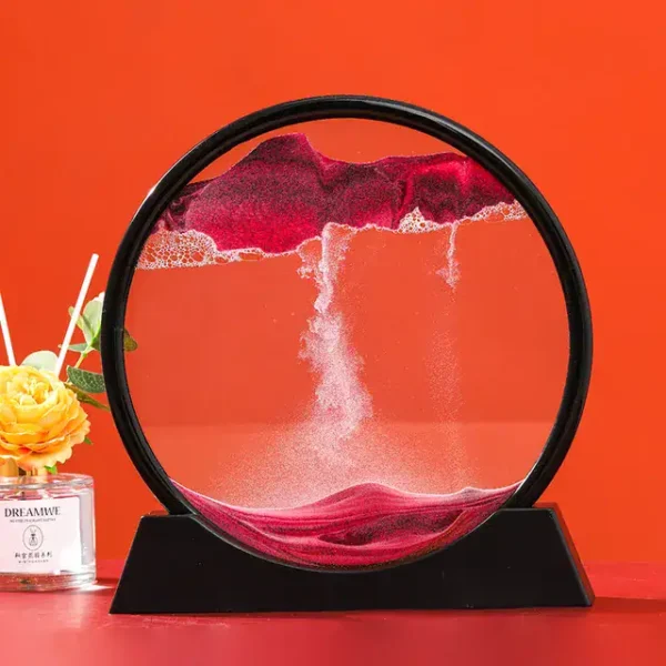 A mesmerizing magnetic levitation sand art sculpture with colorful sand flowing inside a circular frame, creating dynamic patterns against an orange background.