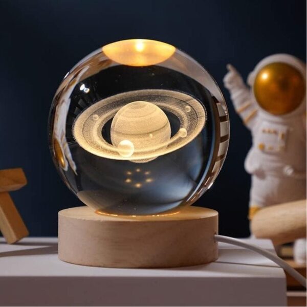 Decorative solar system globe with illuminated planets inside a glass sphere, perfect for science decor and educational purposes.