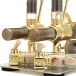 Close-up of a magnetic stirring device with glass tubes and brass components used in scientific experiments and educational demonstrations.