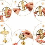 Close-up of hands demonstrating a magnetic gyroscope with a gold-colored frame and black magnetic components, illustrating physics principles.