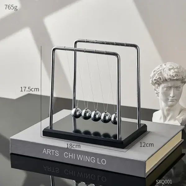 Elegant Newton's Cradle desktop toy with five metallic balls demonstrating physics principles. Perfect for science decor and educational purposes.
