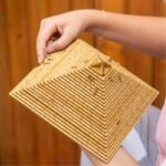 Wooden geometric puzzle with interlocking pieces, designed as an educational brain teaser toy for cognitive development and problem-solving skills.
