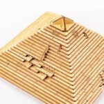 Wooden pyramid model with stepped design and hieroglyphic details, perfect for educational displays and science decor.