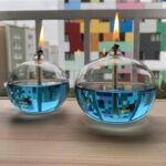 Brightly colored glass water lamps with floating flames and digital-inspired reflections, perfect for science decor and educational displays.