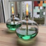 Bunsen burner model with green liquid in glass containers, demonstrating chemical reactions and safety in science experiments.