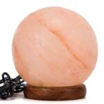 A Himalayan salt lamp with a wooden base, emitting a warm, soothing glow, perfect for science-themed decor and educational environments.