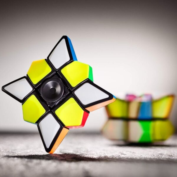 Colorful star-shaped Rubik's Cube puzzle with black edges and vibrant yellow, green, orange, and white faces, designed for brain training and educational fun.