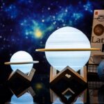 Illuminated planet lamps resembling planets with wooden stands, perfect for science decor and educational displays.