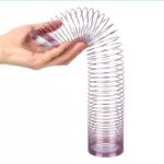 Hand holding a magnetic spiral fidget toy with a metal coil, demonstrating its flexible and mesmerizing movement.