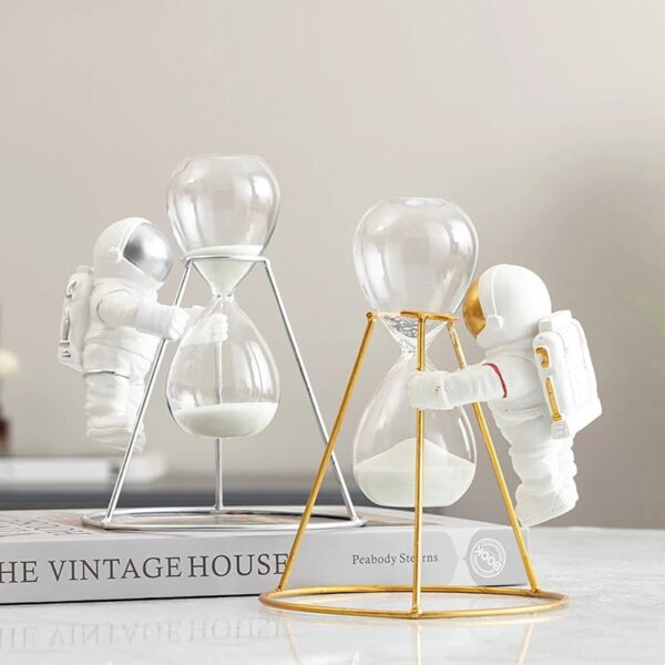 Astronaut figures with hourglasses and scientific decor items for educational and decorative purposes.