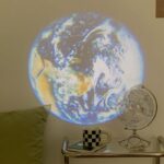 Realistic Earth globe projection on wall, showcasing continents and oceans, perfect for educational decor and science-themed room setups.