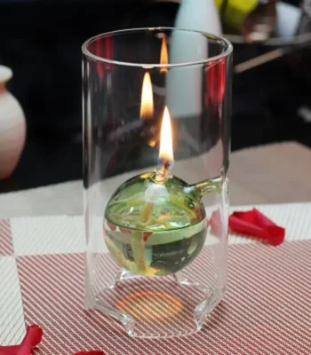 Glass container with a floating candle and liquid, demonstrating scientific principles of combustion and buoyancy.