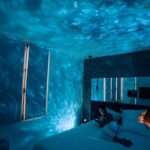 Ceiling star projector illuminating bedroom with a starry night sky pattern, creating a relaxing and magical atmosphere for sleep or relaxation.