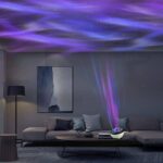 A starry sky projector illuminating a modern living room with purple and blue light patterns on the ceiling and walls.