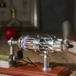 Demonstration of a thermoelectric generator with metal components and wiring on a wooden base, showcasing scientific principles of heat-to-electricity conversion.