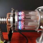 High-tech scientific apparatus with glowing glass tubes and metal components, showcasing advanced experimental equipment.