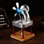 Small desktop Stirling engine demonstrating thermodynamic principles with metal and wood components.