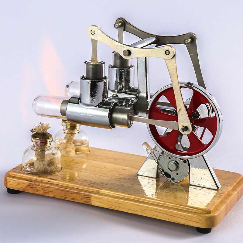 A detailed miniature steam engine model with metal components, red flywheel, and wooden base, demonstrating basic principles of steam power and mechanics.