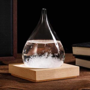 A glass flask with a narrow neck containing a bubbling chemical reaction, placed on a wooden base on a dark background.