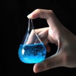 Hand holding a laboratory flask with blue liquid and bubbles, scientific experiment, science education, chemistry, laboratory equipment, science demonstration, science kit, educational science toy, sc.